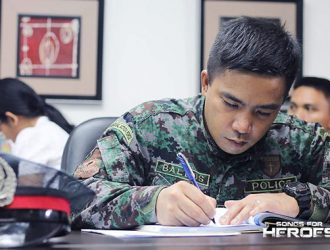 A representative from the AFP jots down notes during a meeting of the Songs for Heroes 2 organizers.